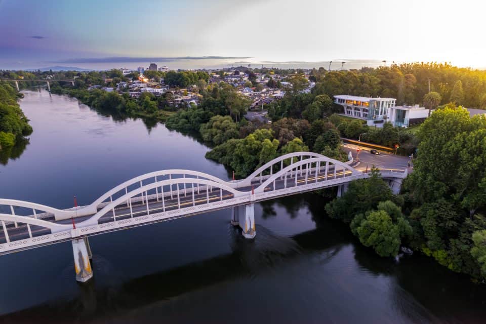 Aerial drone view at sunset, looking up the Waikato River towards the CBD, over the city of Hamilton (Kirikiriroa) in the Waikato region of New Zealand web-hosting